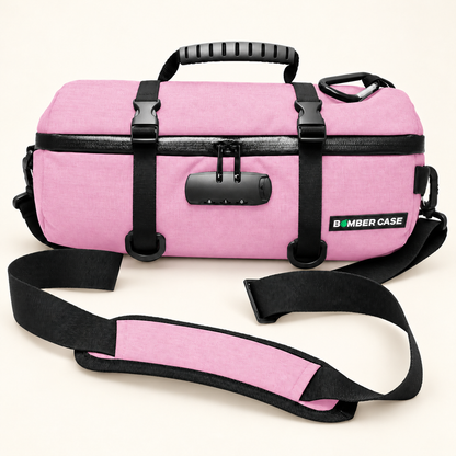 Pink 14-inch Bomber Case locking duffle with cinch straps, a combination lock and a padded shoulder strap.