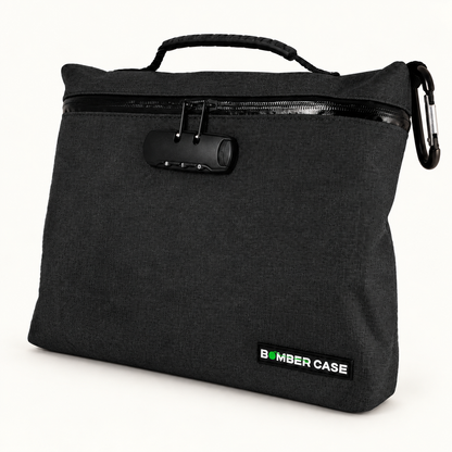 Black XL Bomber Case locking bag with top handle, combination lock and side carabiner on an ivory background.