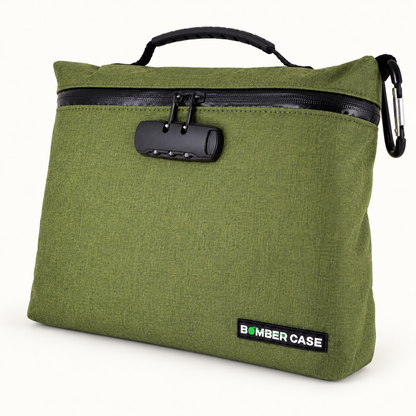 Green XL Bomber Case locking bag with top handle, combination lock and side carabiner on an ivory background.